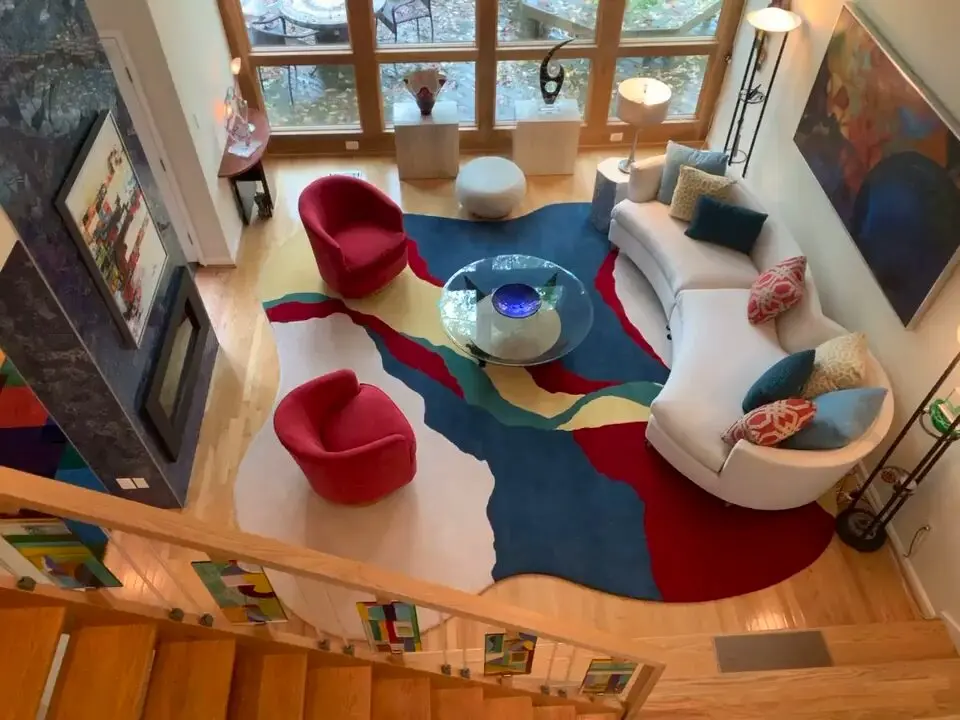 a living room with a colorful rug and a couch
