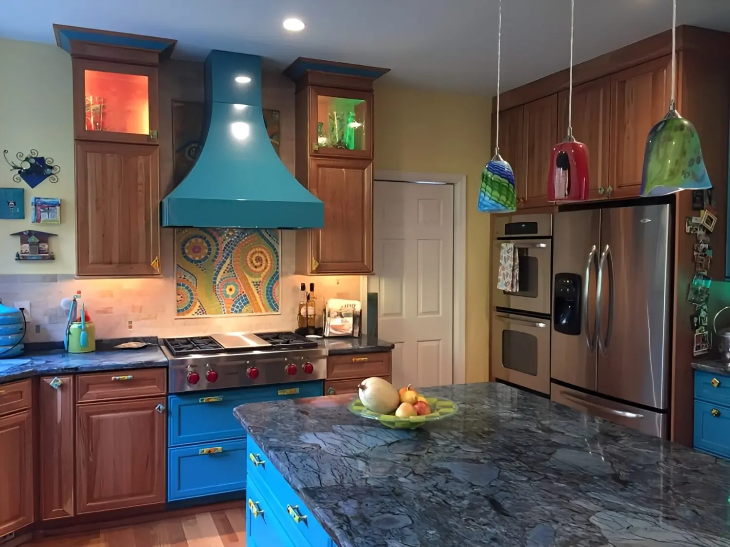a kitchen with a marble countertop and stainless steel appliances