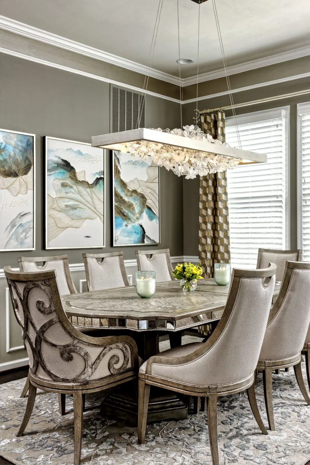 a dining room with a chandelier and chairs