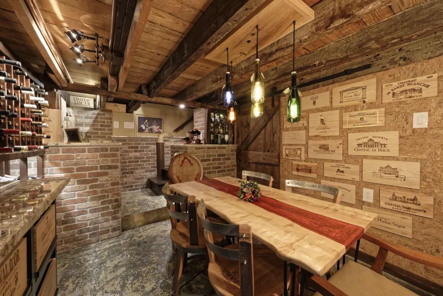 a room with a table and chairs and wine bottles